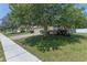 Exterior of a well-kept home featuring a brick paver driveway and mature trees at 10138 Lenox St, Clermont, FL 34711