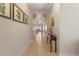 A long hallway featuring tile flooring and decorative wall art at 10138 Lenox St, Clermont, FL 34711