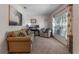 Cozy living room with a comfortable sofa, chair, and a large window for natural light at 10138 Lenox St, Clermont, FL 34711