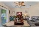 The open living room features tile floors, a ceiling fan, and access to the backyard at 10138 Lenox St, Clermont, FL 34711
