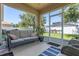 Screened-in porch offering comfortable seating with views of the fenced backyard at 10138 Lenox St, Clermont, FL 34711