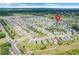 Expansive aerial view of a residential community showcasing single-Gathering homes and lush green spaces at 11284 Amber Ridge Dr, Zellwood, FL 32798