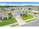 Aerial view of a home with a well-manicured lawn, set in a neighborhood with tree-lined streets at 11284 Amber Ridge Dr, Zellwood, FL 32798