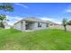 Spacious backyard with lush green grass, a patio, and a privacy fence creating a serene outdoor space at 11284 Amber Ridge Dr, Zellwood, FL 32798