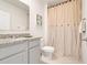 Bright bathroom featuring a sink with granite counters and a shower with beige curtain at 11284 Amber Ridge Dr, Zellwood, FL 32798