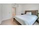 Bedroom featuring two doors and a bed with a wooden headboard and simple decor at 11284 Amber Ridge Dr, Zellwood, FL 32798