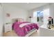 Bright bedroom with a comfy bed, white furniture, and natural light from the window at 11284 Amber Ridge Dr, Zellwood, FL 32798
