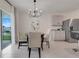 Cozy dining area adjacent to kitchen with backyard access and neutral decor at 11284 Amber Ridge Dr, Zellwood, FL 32798