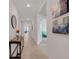 Bright hallway with neutral tile, white walls and entry to the living spaces at 11284 Amber Ridge Dr, Zellwood, FL 32798