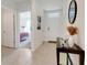 Neutral hallway with views to a bedroom and the front door entrance at 11284 Amber Ridge Dr, Zellwood, FL 32798