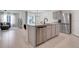 Open concept kitchen with bar seating, granite counters and stainless steel appliances at 11284 Amber Ridge Dr, Zellwood, FL 32798