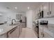 Spacious kitchen featuring stainless steel appliances, granite countertops, and ample cabinet space at 11284 Amber Ridge Dr, Zellwood, FL 32798