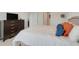 Comfortable bedroom features a soft bed with colorful pillows and a wooden dresser at 11284 Amber Ridge Dr, Zellwood, FL 32798