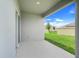 Covered patio with views of the well-maintained lawn and neighboring homes at 11284 Amber Ridge Dr, Zellwood, FL 32798