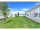 Well-maintained yard featuring lush green grass and partial side view of the single Gathering house at 11284 Amber Ridge Dr, Zellwood, FL 32798