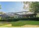 Backyard of a residence featuring a screened-in patio and a large privacy hedge at 1161 Coastal Cir, Ocoee, FL 34761