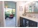 Elegant bathroom features a modern vanity, stylish mirror, and open-air patio access at 1161 Coastal Cir, Ocoee, FL 34761