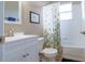 Charming bathroom with a white vanity, floral shower curtain, and a window providing natural light at 1161 Coastal Cir, Ocoee, FL 34761