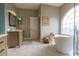 Bright bathroom features double sinks, a stand alone tub, and glass shower at 1161 Coastal Cir, Ocoee, FL 34761