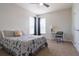 Cozy bedroom features two windows, ceiling fan, and comfortable furnishings, perfect for relaxation at 1161 Coastal Cir, Ocoee, FL 34761