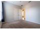Bright bedroom with neutral walls and carpet, double doors, and an ensuite entrance at 1161 Coastal Cir, Ocoee, FL 34761