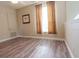 Bright, neutral bedroom features wood flooring, a window with curtains, and recessed lighting at 1161 Coastal Cir, Ocoee, FL 34761