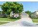 Inviting home with well-kept lawn and mature trees, featuring an attached two-car garage at 1161 Coastal Cir, Ocoee, FL 34761