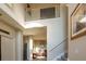 Two-story foyer with staircase and view into the living room, showcasing natural light and an open layout at 1161 Coastal Cir, Ocoee, FL 34761