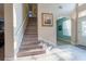 Bright foyer featuring a staircase, neutral paint, tiled flooring, and natural light from the entry at 1161 Coastal Cir, Ocoee, FL 34761