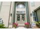 Inviting front entrance featuring double doors, sidelights, an arched transom window, and flower-filled planters at 1161 Coastal Cir, Ocoee, FL 34761