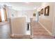 Bright hallway featuring wood floors, neutral walls with decorative artwork, and natural light at 1161 Coastal Cir, Ocoee, FL 34761