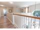 Hallway with wood floors leads to staircase and bathroom at 1161 Coastal Cir, Ocoee, FL 34761