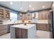 Modern kitchen with stainless appliances, island, custom cabinets, and a bright and airy atmosphere at 1161 Coastal Cir, Ocoee, FL 34761