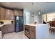 Stylish kitchen with a stainless refrigerator, large island, and open layout perfect for entertaining at 1161 Coastal Cir, Ocoee, FL 34761