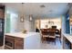 Bright kitchen features an island with modern lighting, stainless appliances, and an open dining area at 1161 Coastal Cir, Ocoee, FL 34761