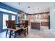 Spacious kitchen and dining area with custom cabinetry, island, and access to the outdoor pool at 1161 Coastal Cir, Ocoee, FL 34761