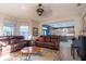 Inviting living room with leather sofas opens to a kitchen, offering ample seating and natural light at 1161 Coastal Cir, Ocoee, FL 34761