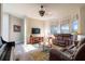 Bright living room features a piano and comfortable seating with large windows for natural light at 1161 Coastal Cir, Ocoee, FL 34761