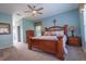 Lovely main bedroom with a ceiling fan and wood furniture at 1161 Coastal Cir, Ocoee, FL 34761
