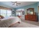 Main bedroom with plush carpet, lots of light, and sitting area at 1161 Coastal Cir, Ocoee, FL 34761