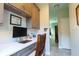 Home office features built-in shelves, a desk, ample storage, and neutral decor at 1161 Coastal Cir, Ocoee, FL 34761