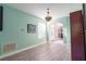 Well-lit office space with light blue walls, stylish light fixture, and an open entryway to the home at 1161 Coastal Cir, Ocoee, FL 34761