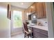 Home office with built-in shelves, a desk, ample storage, and a bright window for natural light at 1161 Coastal Cir, Ocoee, FL 34761