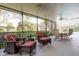 Inviting screened-in patio with comfortable wicker seating, adjacent to both dining and lounge areas at 1161 Coastal Cir, Ocoee, FL 34761