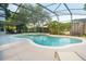 Backyard pool and spa area with a large screened-in enclosure and access to a covered patio at 1161 Coastal Cir, Ocoee, FL 34761