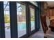 View of backyard pool and patio through open French doors in an open-concept kitchen at 1161 Coastal Cir, Ocoee, FL 34761