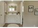 Nicely renovated bathroom featuring a new vanity, a large mirror, modern fixtures, and neutral paint at 1220 Dustin Dr, Lady Lake, FL 32159