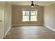Neutral bedroom with wood floors, bright windows, and ample space for a relaxing private retreat at 1220 Dustin Dr, Lady Lake, FL 32159