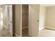 Bedroom closet view showing functional storage space and neutral finishes connecting to other rooms at 1220 Dustin Dr, Lady Lake, FL 32159