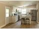 Modern kitchen featuring white cabinets, stainless steel appliances, island with stool seating, and updated fixtures at 1220 Dustin Dr, Lady Lake, FL 32159